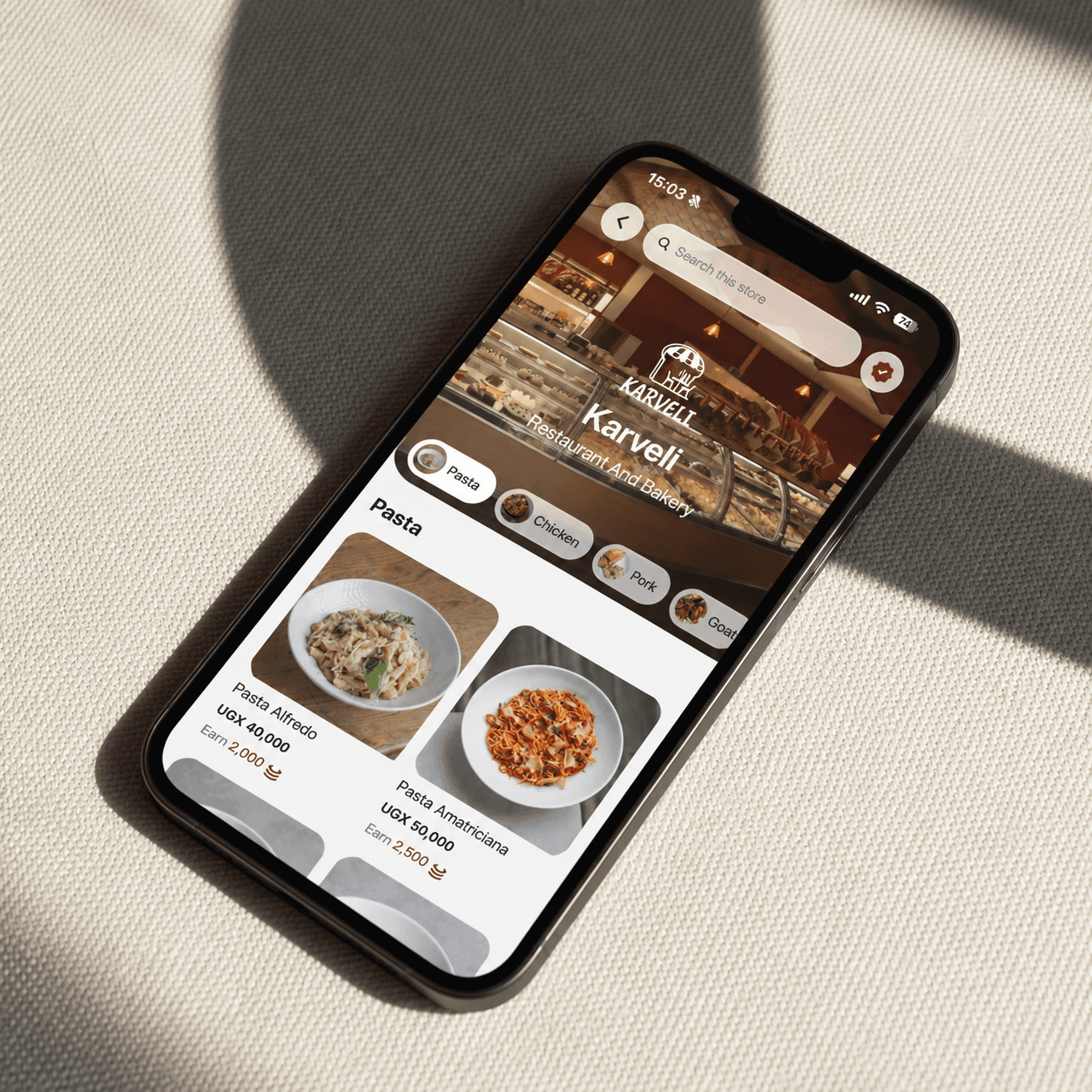 A phone on a linen surface showing the Karveli storefront menu, with Coinz earned on each dish
